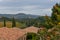 view from the Banfi wine resort into the rolling hills of the Toscana with view of castle and hilltop villages