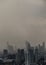 View of Bangkok with city skyscrapers covered in a dense smog before a rain