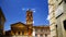 View of the Basilica of Santa Maria in Trastevere from the homonymous alley, on a sunny day with blue sky with clouds