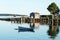 View of Bass Harbor with row boat, dock, labster traps, and fish