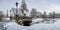 View of Bastion Hill park and The Freedom Monument in Riga, Latvia. Winter landscape in snowy park with beautiful small bridge