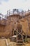 View of a bastion and a treadwheel crane at the Guedelon castle in Treigny, France. This site is actually under construction, as