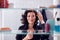 View Through Bathroom Cabinet Of Mature Businesswoman Getting Ready For Work Checking Hair