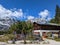 View of the Bavarian mountain hut with a beer garden, tables, and benches in Ramsau, Germany