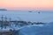 View of the bay, covered with ice. In the distance among the ice floes two cargo ships.