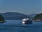 View of BC Ferries RORO vessel MV Queen of New Westminster approaching between islands in the Salish Sea.