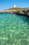 View on the beach Calo Roig and the Defense Tower Alcaufar on Menorca