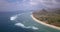 A view beach coast line with coming waves and mountain.