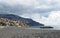 View of the beach at funchal with coastal city buildings and surrounding hills