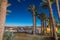 View of beach with palm trees in Eilat resort at dusk