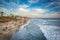 View of the beach from the pier at sunset, in Oceanside, California.