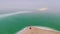 View of the beach at resort village of Ein Bokek. view from top. aerial view. young man walking on the shore of the dead