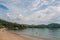 View of beach, sea and forest on cloudy day in Paraty Mirim.