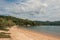 View of beach, sea and forest on cloudy day in Paraty Mirim.