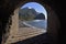 View of beach through tunnel