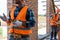 View of bearded constructor gesturing near brick walls