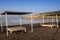 View of the beautiful beach through a Balinese bed.Sun beds with a roof and canopies on the promenade