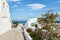 View of the beautiful blue Aegean Sea and Caldera from the whitewashed hillside town of Oia, Santorini, Greece.