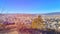 View of the beautiful city from a hill of coniferous forest.