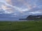 View on beautiful cliffs in Hloduvik cove in west fjords nature reserve Hornstrandir in Iceland, with green meadow, sea shore beac