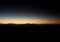 The view of beautiful color gradation of the sky at sunrise in the mountainous area as seen from the observation point on a hill.
