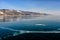 View of beautiful drawings on ice from cracks and bubbles of deep gas on surface of Baikal lake in winter, Russia