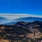 View of the beautiful Kuri village of Kalinchowk, Nepal from the top of a mountain with the clouds and mountains in the distant