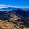 View of the beautiful Kuri village of Kalinchowk, Nepal from the top of a mountain with the clouds and mountains in the distant