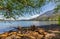 View of a beautiful lake with mountains in the background in sunny summer day