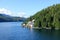 A view of a beautiful lighthouse in a remote location surrounded by forest and ocean along the inside passage ferry route.