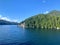 A view of a beautiful lighthouse in a remote location surrounded by forest and ocean along the inside passage ferry route.