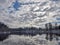 View of beautiful river winter day, snowy trees, many clouds, beautiful reflections, calm river water