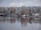 View of beautiful river winter day, snowy trees, many clouds, beautiful reflections, calm river water