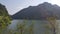 View of beautiful scene of river water and green trees on large hills