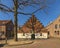 View of a beautiful stepped gable house in a Dutch village, photographed in early spring, the first spring day, with trees that st