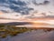 View on a beautiful sunset over Burren and Atlantic ocean, Cloudy sky, Sand dunes. West coast of Ireland