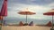 View of beautiful and tranquil beach scene with sea in the horizon and breeze blowing softly on sun umbrella on the sand