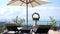 View at beautiful tropical terrace with sunbeds, umbrella and sea view