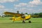 View of beautiful ultralight airplane in field on autumn day