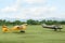 View of beautiful ultralight airplanes in field on autumn day