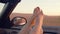 View of beautiful womans legs inside a cabriolet during a road trip - young girl having fun traveling in a convertible