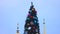 View of beautifully decorated tall Christmas tree against church, sequence