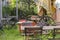 View into a beer garden with various mixed garden furniture and old wooden cart wheels