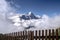 View from behind the fence to the Eiger mountain surrounded by clouds.