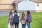 View from behind of a Group of school girls walking to school together