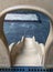 View behind a white slide in a playground with blue ceramic flooring