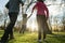 View from behind of young parents holding their sons hands lifting him in a playful image