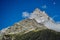 A view of Belalakaya mountain peak. Mountain with slow and blue sky, sunny day.Dombay, Karachay-Cherkess republic