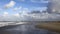 View on belgian coast with cranes of zeebrugge harbour in the background