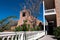 View of the bell tower, main entrance, and white cross of San Miguel Church beside the Lamy Building in Santa Fe, New Mexico, USA